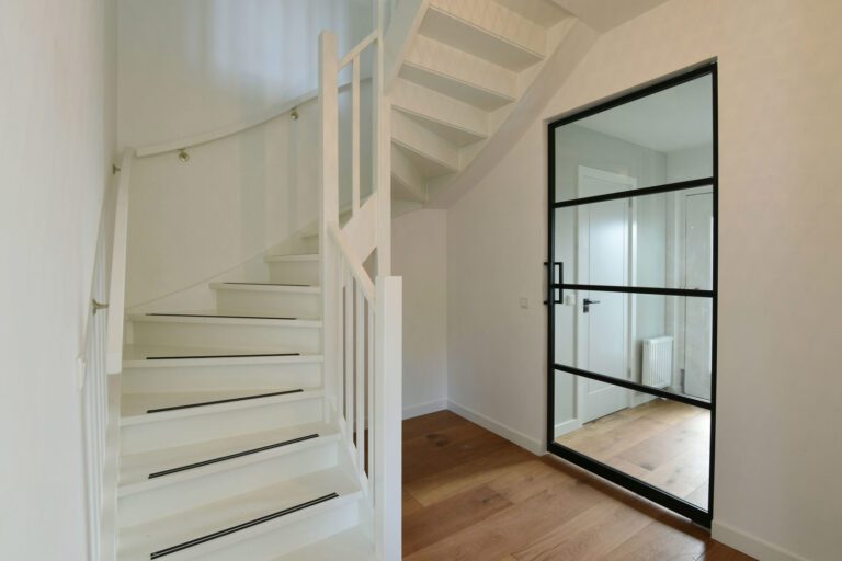 White painted staircase beside a steel-framed glass door – Eikbosserweg 210, Hilversum