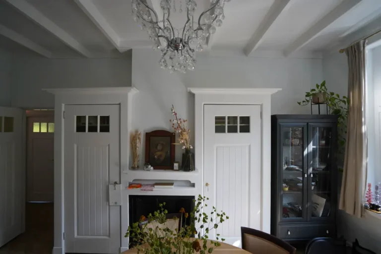 Classic room with white panelled doors and a chandelier