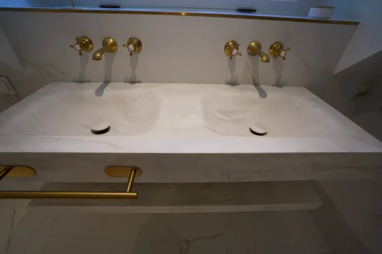 Double marble washbasin with gold taps