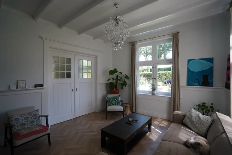 Renovated living room with a bay window and beamed ceiling
