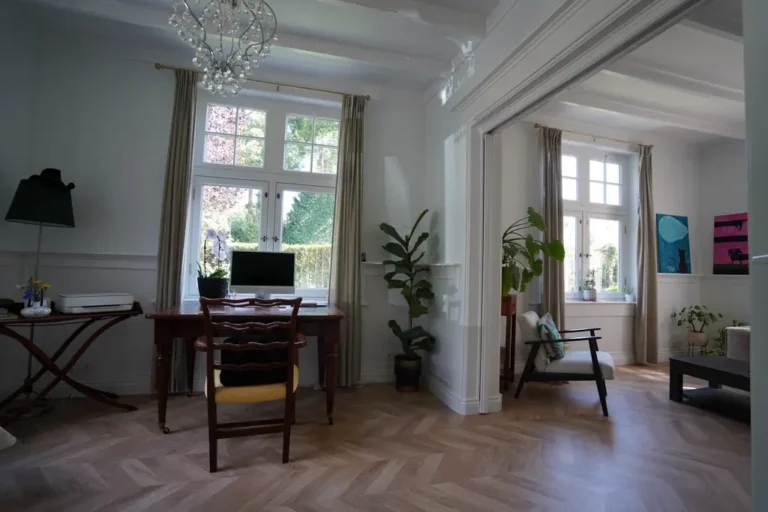 Open study connecting to the living room with herringbone floors