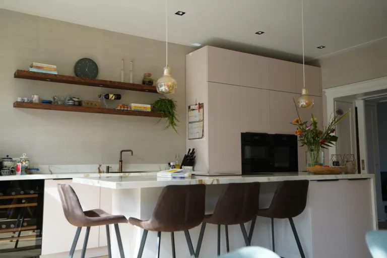 Kitchen with built-in ovens, brass tap and walnut floating shelves – Meindert Hobbemastraat, Heemstede