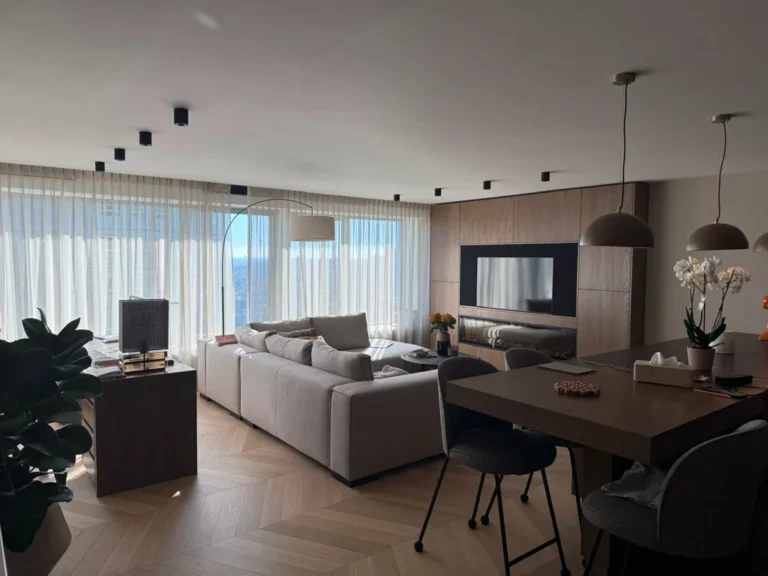 Modern open-plan living and dining room with a wood-panelled feature wall