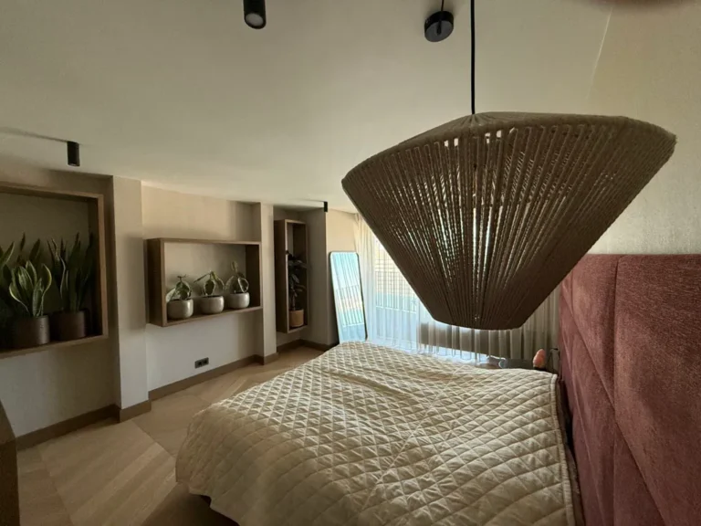 Bedroom with a woven pendant light and built-in niches