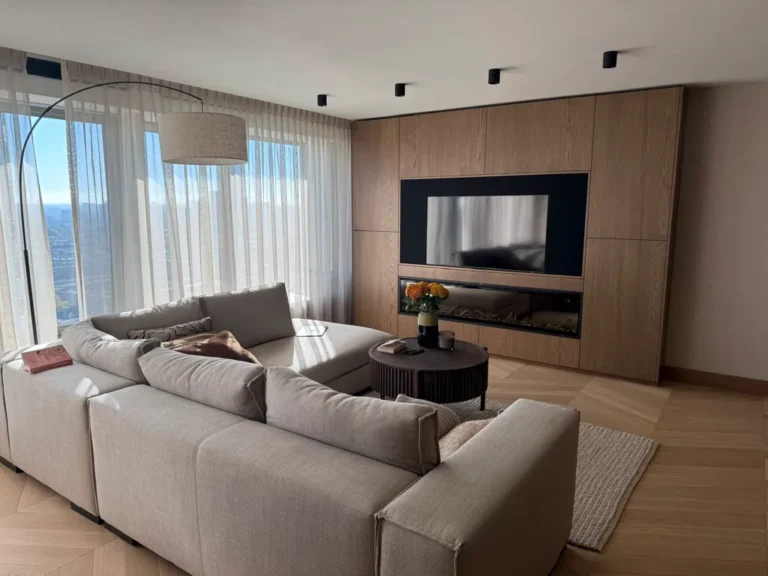 Living room with a large sectional sofa and a linear fireplace