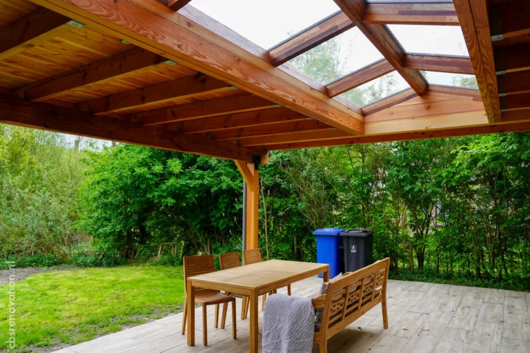 Covered wooden veranda with a dining set overlooking the garden
