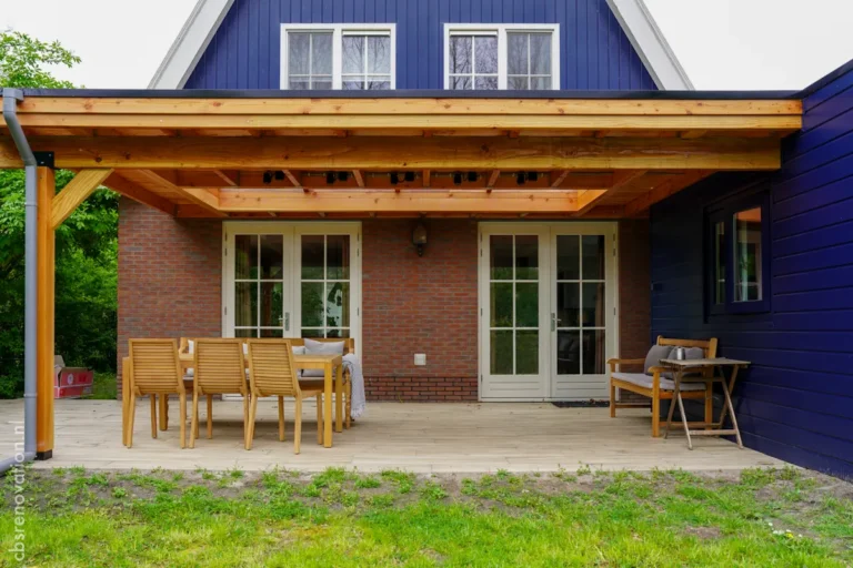 Covered veranda along the brick rear facade with French doors