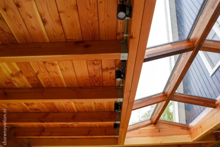 Spotlights mounted under the wooden veranda roof beams