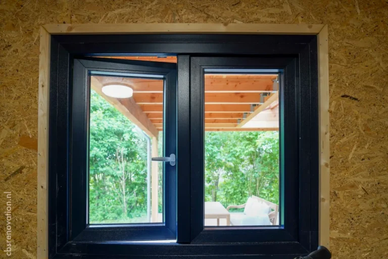 Black-framed window in the garden room overlooking the garden