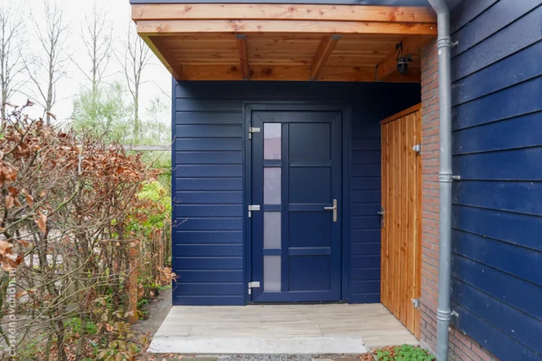 Navy blue entrance door of the garden room, exterior view