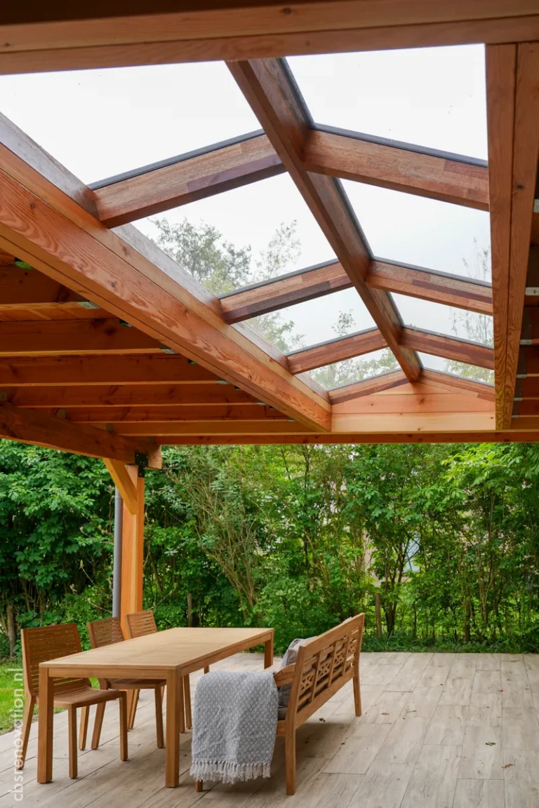 Wooden veranda with a glass roof and a teak dining set in the garden