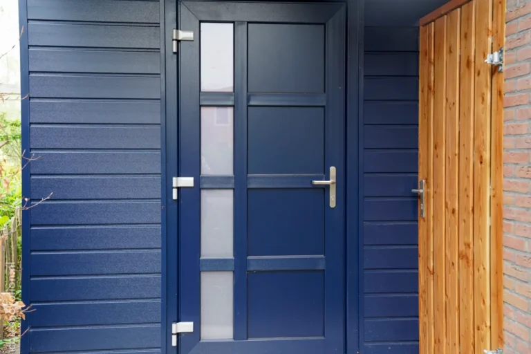 Navy blue entrance door and wooden side gate, close-up