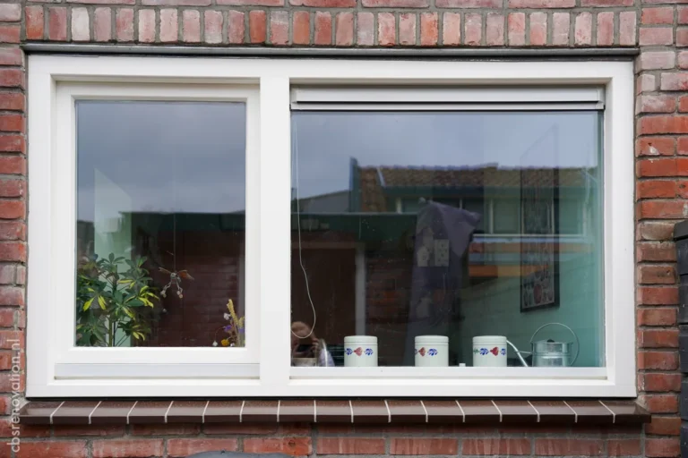 White-framed window in the brick rear facade