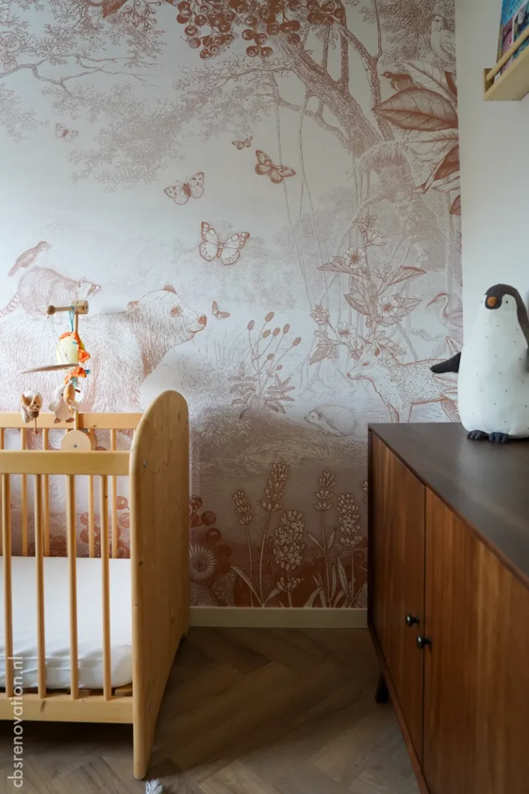 Nursery with a wooden cot and botanical mural wallpaper