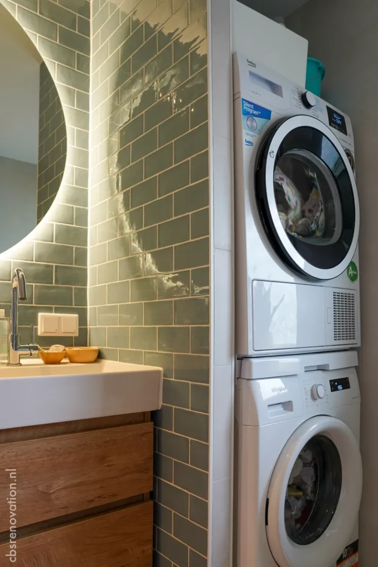 Bathroom with a stacked washer and dryer and a green tiled wall