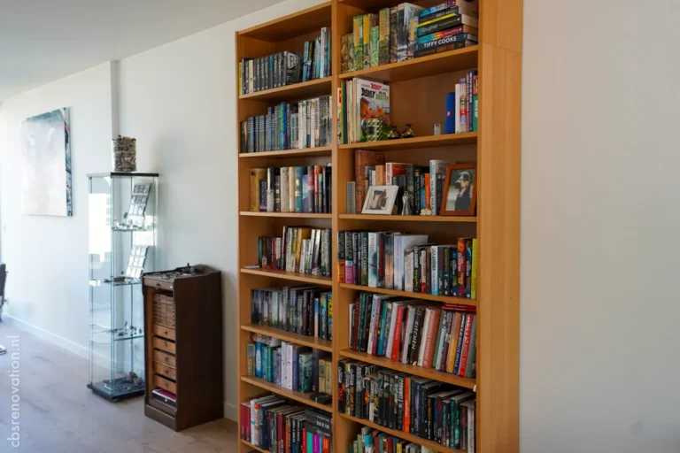 Wooden bookshelves filled with books, showcasing a modern living space in a recently renovated home.