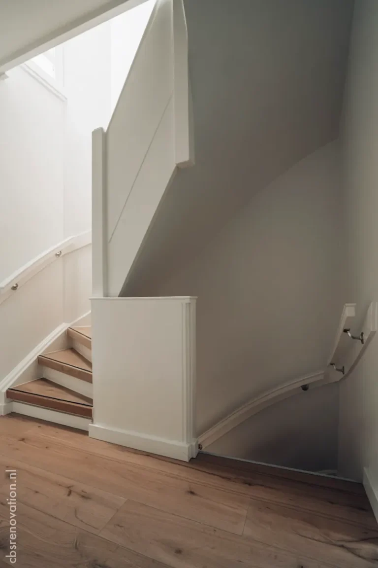 White-painted staircase with a wall-mounted rail and oak floor
