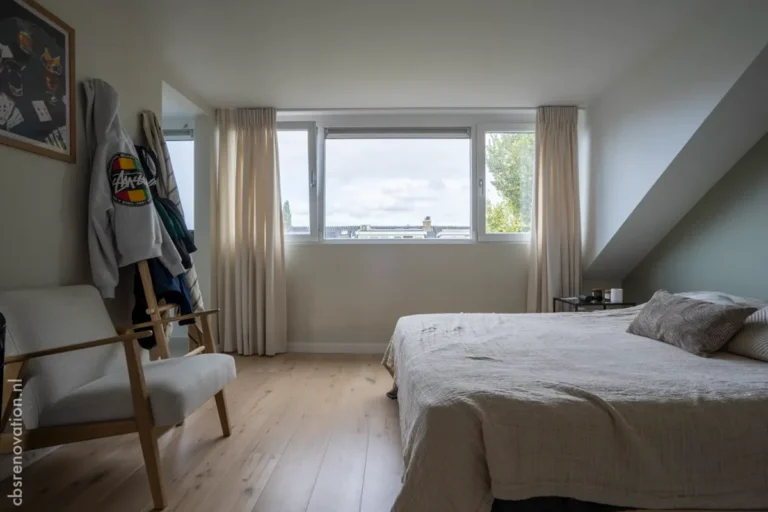 Attic bedroom with a large bed and a rooftop view