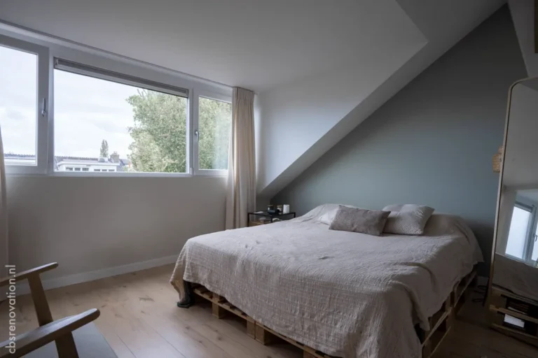 Bedroom with a window and a sloped ceiling