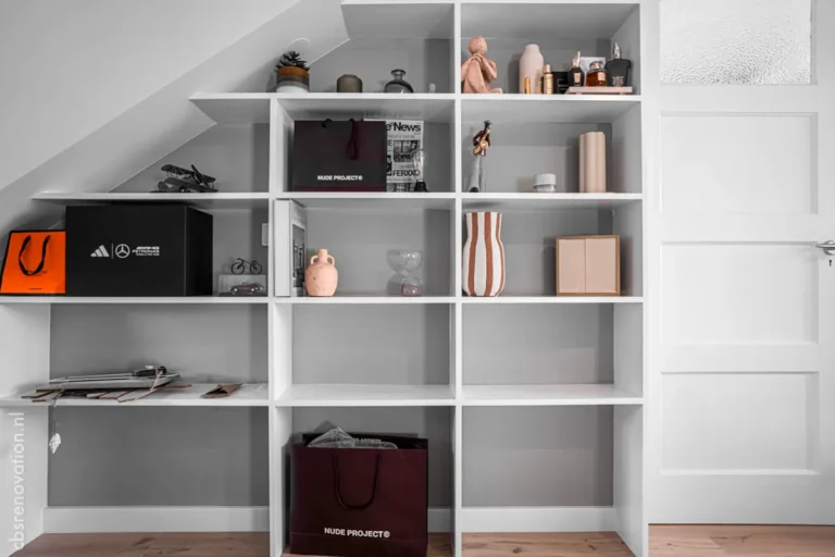 Built-in open shelving under a sloped ceiling