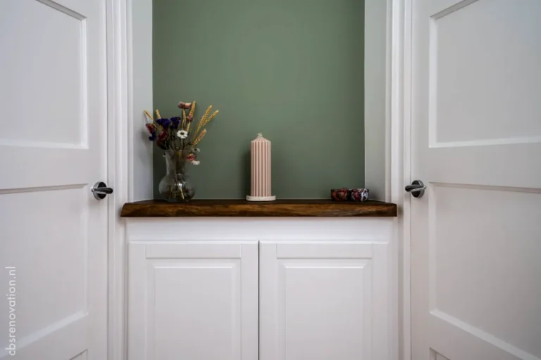 Decorative niche with a wooden shelf between two white doors