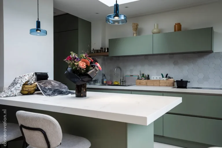 Modern kitchen with sage-green cabinets and a white island