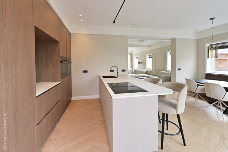 Kitchen with full-height wood units and a white island with an induction hob