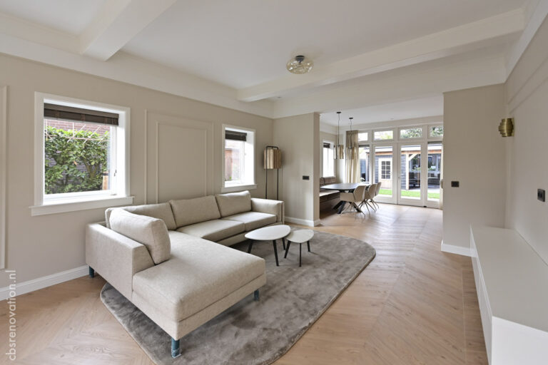 Living room with a sofa and a view through to the garden doors