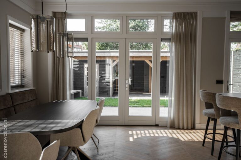 Dining area with an oval table and garden doors onto the terrace