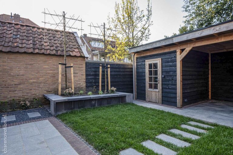 Back garden with new planting, a stone stepping path and the black timber garden room