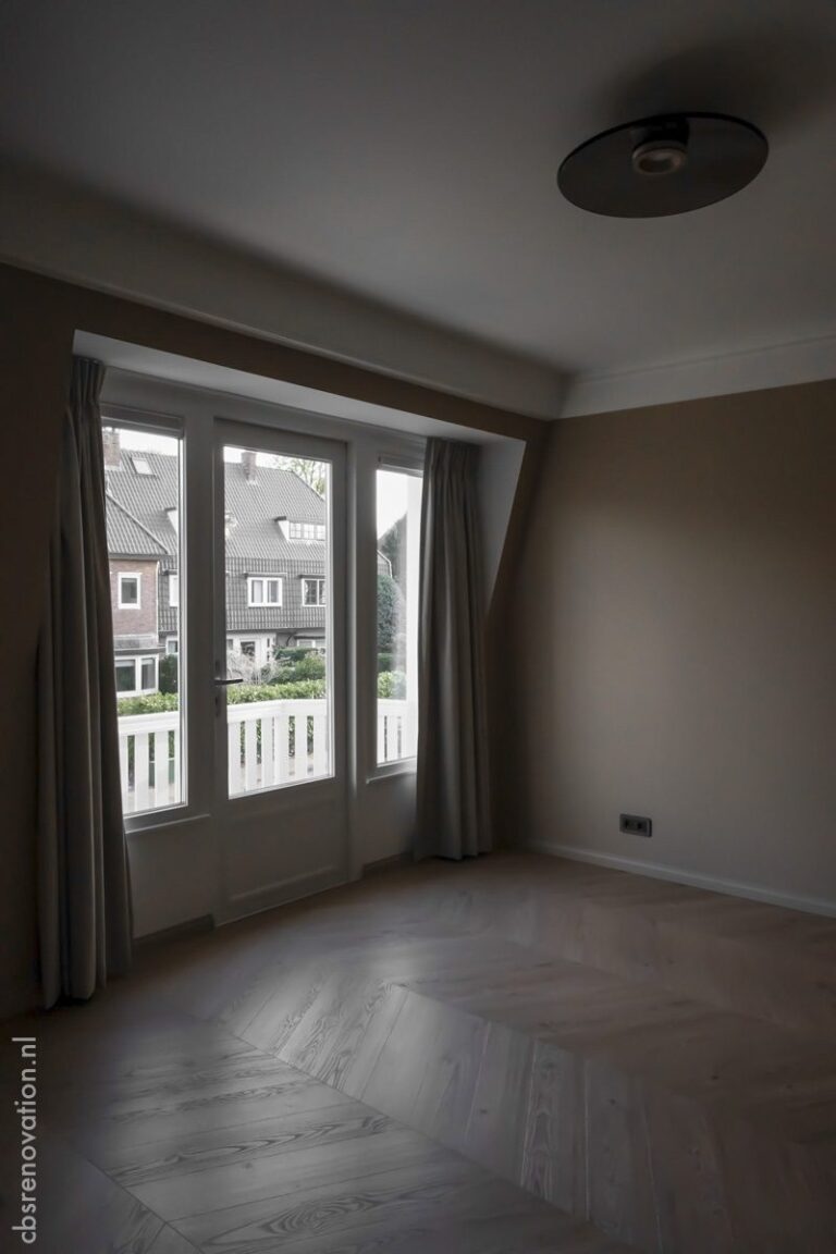 Top-floor room with a dormer window and a herringbone floor