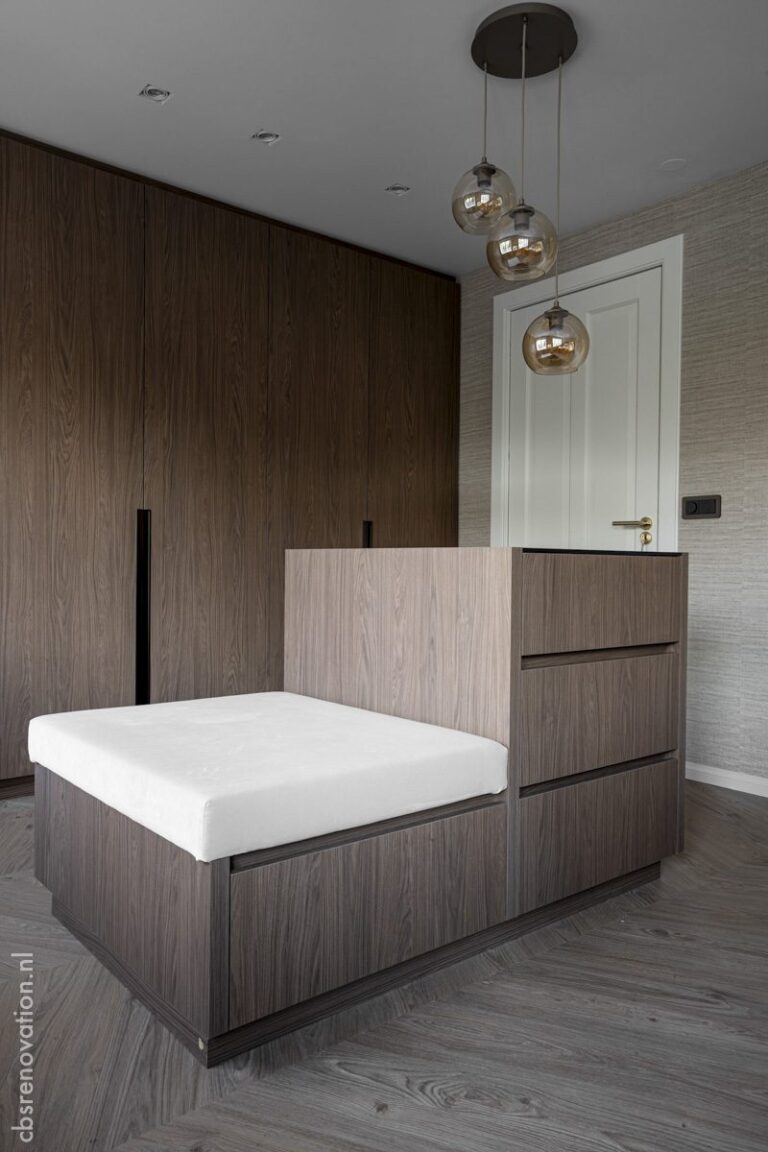 Bedroom with a fitted wood wardrobe wall and a built-in bed base