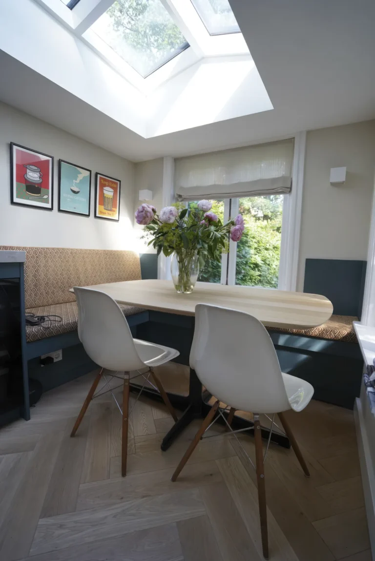 Dining nook lit by a roof light above the built-in banquette