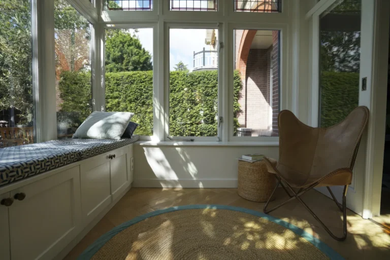 Garden room with built-in bench seating and full-height windows