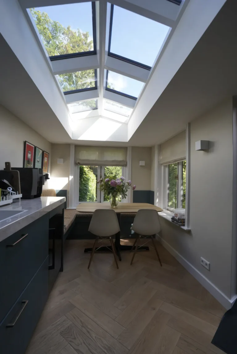 Study area under the roof light with dark fitted cabinetry